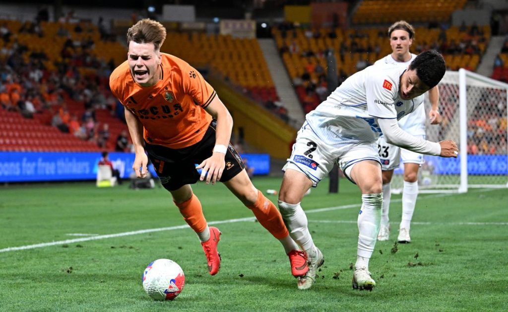 Justin Vidic of the Roar is tackled by Hiroki Sakai of Auckland FC at Suncorp Stadium.